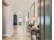 Bright foyer with wood floors, console table, mirrors, and an open view to the living area at 9382 Quaker St, Arvada, CO 80007