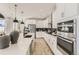 Bright kitchen with white cabinetry, stainless steel appliances, and modern fixtures at 9382 Quaker St, Arvada, CO 80007