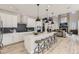 Gourmet kitchen with island seating, stainless steel appliances, and open layout to living area at 9382 Quaker St, Arvada, CO 80007