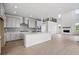 Open-concept kitchen with a large center island, stainless steel appliances, and stylish gray cabinetry, perfect for entertaining at 9382 Quaker St, Arvada, CO 80007