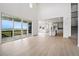 Open-concept living area with hardwood floors, large sliding doors to the balcony, a sleek kitchen, and modern staircase at 9382 Quaker St, Arvada, CO 80007