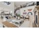 Open concept living room featuring high ceilings, fireplace, and loft area at 9382 Quaker St, Arvada, CO 80007