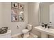 Stylish half bath with modern fixtures, decorative art, and clean design at 9382 Quaker St, Arvada, CO 80007