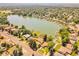 Stunning aerial view of a lakefront property with mature trees and a private dock at 4790 W Evans Ave, Denver, CO 80219