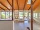 Bright living room with wood beam ceiling, fireplace, and picturesque lake views through large windows at 4790 W Evans Ave, Denver, CO 80219