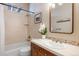 Bathroom features a single vanity, tub with shower, and decorative mirror and fixtures at 4002 Bell Mountain Dr, Castle Rock, CO 80104