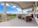 Outdoor deck with wicker furniture and beautiful mountain views creating a relaxing space at 4002 Bell Mountain Dr, Castle Rock, CO 80104