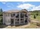 Expansive two-story home with a large balcony and stone pillar supports at 4002 Bell Mountain Dr, Castle Rock, CO 80104