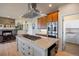 Well-equipped kitchen featuring custom cabinetry, stainless steel appliances, and a center island at 4002 Bell Mountain Dr, Castle Rock, CO 80104