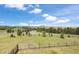 Expansive green landscape with a beautiful hillside view and winding roads at 4002 Bell Mountain Dr, Castle Rock, CO 80104