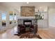 Sitting area featuring a stone fireplace and large windows offering scenic views at 4002 Bell Mountain Dr, Castle Rock, CO 80104