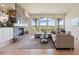 Bright living room with a stone fireplace, hardwood floors, and expansive windows with scenic views at 4002 Bell Mountain Dr, Castle Rock, CO 80104