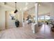 Open-concept living area with a stone fireplace and large windows showcasing scenic views at 4002 Bell Mountain Dr, Castle Rock, CO 80104