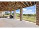 Covered patio with stone pillars overlooking a spacious backyard and serene landscape views at 4002 Bell Mountain Dr, Castle Rock, CO 80104