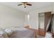 Comfortable bedroom featuring a ceiling fan, hardwood floors, and closet at 9650 Huron St # 12, Thornton, CO 80260