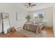 Relaxing bedroom with hardwood floors, a cozy bed, and ample natural light from the large window at 9650 Huron St # 12, Thornton, CO 80260