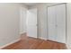 Bedroom with a pair of closets, white paint and hardwood floors at 9650 Huron St # 12, Thornton, CO 80260