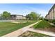 Exterior view of the complex with a grassy area and sports court at 9650 Huron St # 12, Thornton, CO 80260
