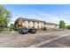 Wide exterior view of the complex with mature trees, landscaping and convenient parking at 9650 Huron St # 12, Thornton, CO 80260