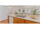 A well-lit kitchen is showcased with stainless steel appliances, double sink, and an open view to the living room at 9650 Huron St # 12, Thornton, CO 80260