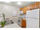 Compact kitchen with stainless steel appliances, white cabinets and countertops, and modern decor at 9650 Huron St # 12, Thornton, CO 80260
