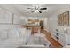 Bright living room featuring a ceiling fan, hardwood floors, and an open concept kitchen with breakfast bar at 9650 Huron St # 12, Thornton, CO 80260
