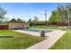 A community pool that is covered in the off season, surrounded by a green lawn at 9650 Huron St # 12, Thornton, CO 80260