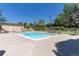 Community pool with lounge chairs and a picnic table near a building at 9650 Huron St # 12, Thornton, CO 80260