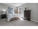 Cozy bedroom features soft gray carpet, a serene blue accent decor, and a sunlit window at 10001 E Evans Ave # 72C, Aurora, CO 80247