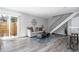 Stylish living room with hardwood floors and sliding glass door at 10001 E Evans Ave # 72C, Aurora, CO 80247