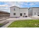 Backyard featuring concrete patio, grassy area, and gray siding at 5201 Lumos Ln, Castle Rock, CO 80104