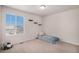 Bedroom featuring neutral carpet, bright window and decorative wall shelving at 5201 Lumos Ln, Castle Rock, CO 80104