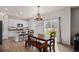 Bright dining area with wood table, flowing into a kitchen with stainless steel appliances at 5201 Lumos Ln, Castle Rock, CO 80104