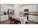 Bright kitchen featuring granite countertops, white cabinetry, and modern stainless steel appliances at 5201 Lumos Ln, Castle Rock, CO 80104