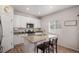 Well-lit kitchen featuring granite countertops, white cabinetry, and modern stainless steel appliances at 5201 Lumos Ln, Castle Rock, CO 80104