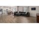 Open-concept living area flows seamlessly into the kitchen, featuring wood floors and ample natural light at 5201 Lumos Ln, Castle Rock, CO 80104