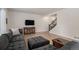 Inviting living room featuring wood floors, neutral walls, and a comfortable, oversized sectional at 5201 Lumos Ln, Castle Rock, CO 80104