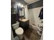 Bathroom with white tile, granite counter and wood style floors at 1171 Geneva St, Aurora, CO 80010