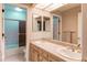 Bright bathroom featuring double sinks, vanity, large mirrors and a shower and bathtub combo at 10291 E Powers Ave, Greenwood Village, CO 80111