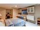 Cozy bedroom with built-in shelving, cabinets, and a comfortable bed in a well-lit basement at 10291 E Powers Ave, Greenwood Village, CO 80111