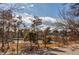 A view of tennis courts in the community in the summer, surrounded by green trees and blue skies at 10291 E Powers Ave, Greenwood Village, CO 80111