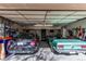 Spacious garage with two parked cars and ample storage space for tools and equipment at 10291 E Powers Ave, Greenwood Village, CO 80111