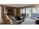 Cozy living room featuring a fireplace, built-in shelves, and sliding glass doors at 10291 E Powers Ave, Greenwood Village, CO 80111