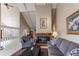 Cozy living room with a fireplace, vaulted ceiling, comfortable seating, and plenty of natural light at 10291 E Powers Ave, Greenwood Village, CO 80111