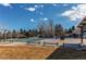 Community pool with many trees, park benches, and diving board at 10291 E Powers Ave, Greenwood Village, CO 80111