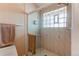 Bathroom with shower behind glass enclosure and decorative glass block window at 10291 E Powers Ave, Greenwood Village, CO 80111