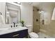 Modern bathroom with glass shower, blue vanity, and matte black fixtures at 6330 E Irwin Pl, Centennial, CO 80112