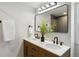 Bathroom with double sink vanity, black fixtures, large mirror, and modern finishes at 6330 E Irwin Pl, Centennial, CO 80112