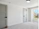 Bright bedroom features neutral walls, gray doors, carpet, and natural light from a double-hung window at 6330 E Irwin Pl, Centennial, CO 80112