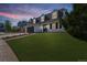 Charming two-story home featuring dormer windows and a well-manicured lawn at dusk at 6330 E Irwin Pl, Centennial, CO 80112